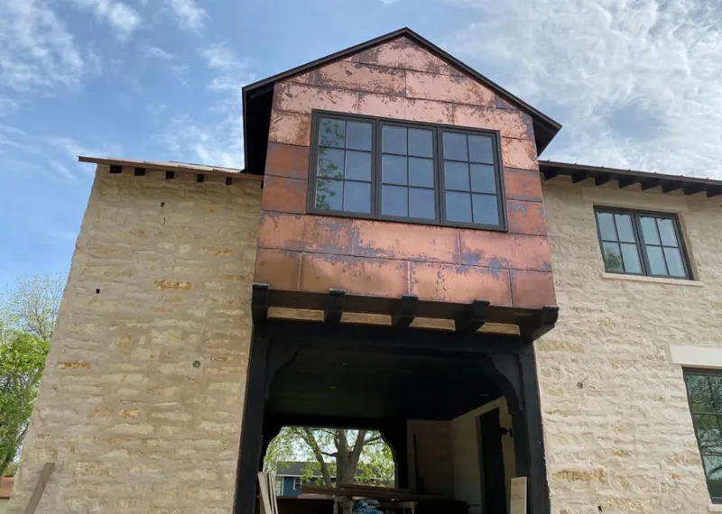 Copper metal panel facade on a stone building for Skylight Installation in Clearwater